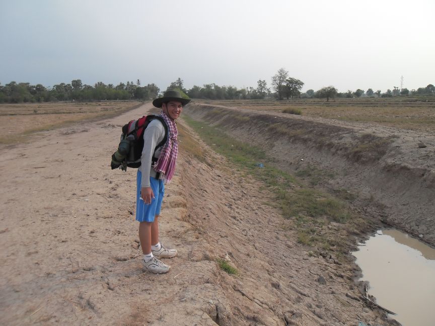 Paul standing next to a canal built by Noit and other children during the Khmer Rouge